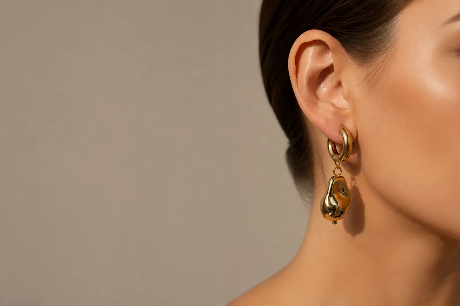 Elegant gold drop earrings showcase unique jewellery with a modern, sophisticated touch.